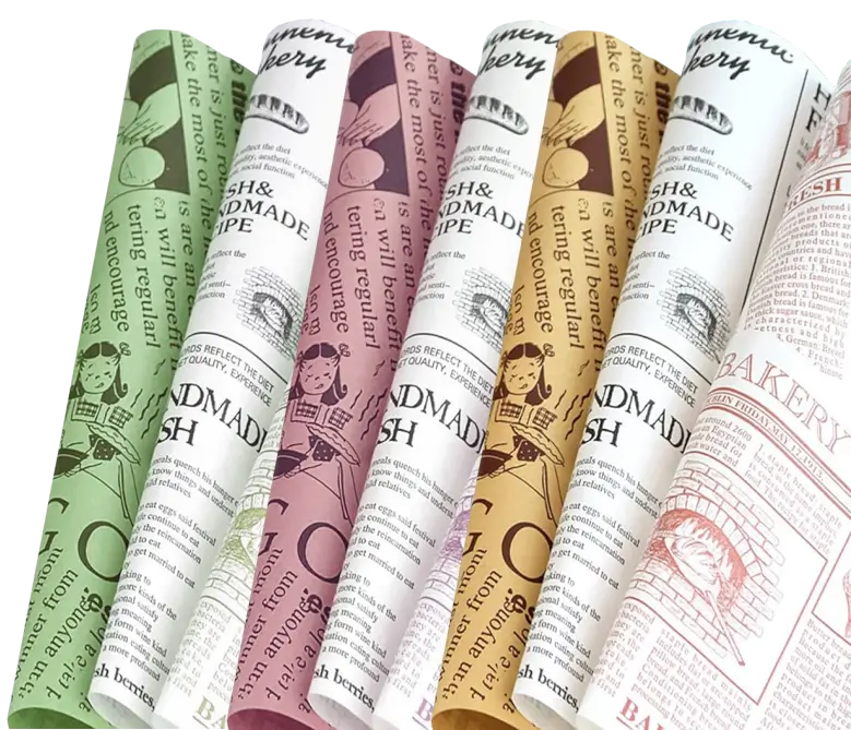 A collection of custom-printed greaseproof paper sheets in various colors with vintage-themed designs