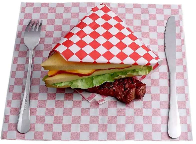 Sandwich wrapped in red and white checkered custom hot paper, served with a grilled meat piece, stainless steel fork and knife, and matching checkered paper lined for presentation