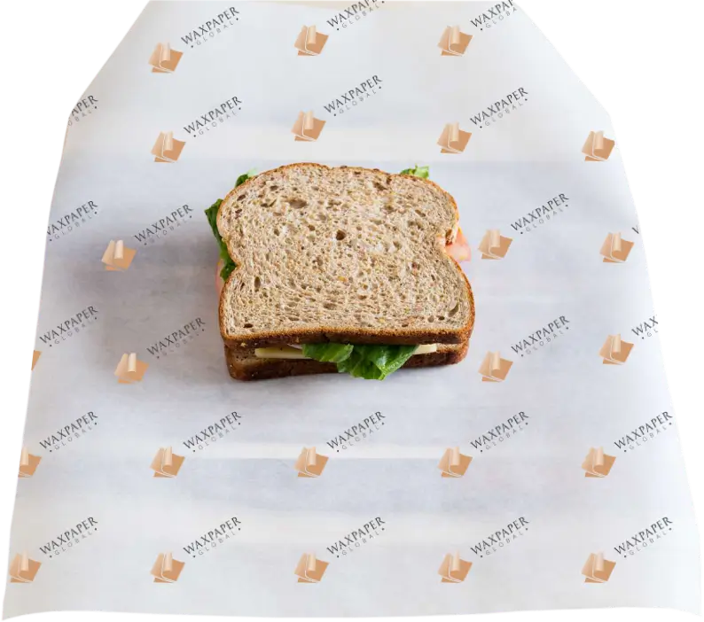 A fresh sandwich placed on custom-printed sandwich paper featuring the Wax Paper Global logo